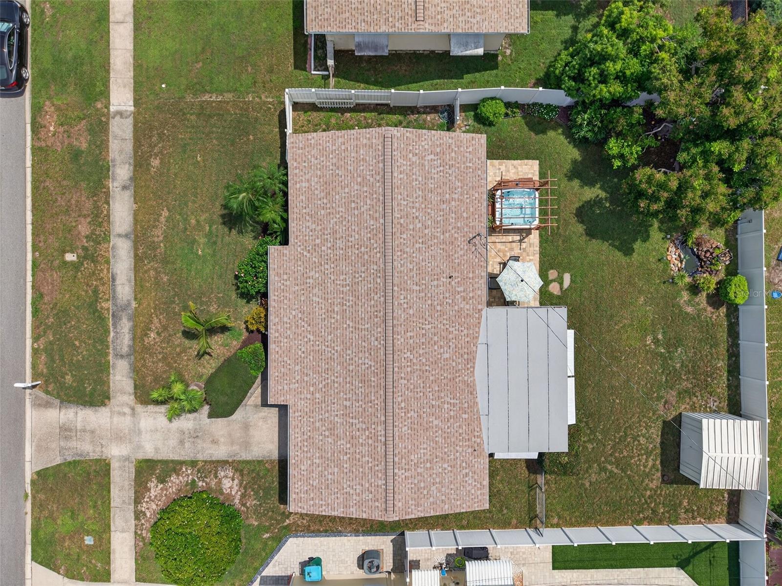 Areial view of the 7,000 square foot lot. Top fence shot area between the fence, and the house is 9.5 feet. Room for recreation vehicles. Vinal fencing in most of the yard.