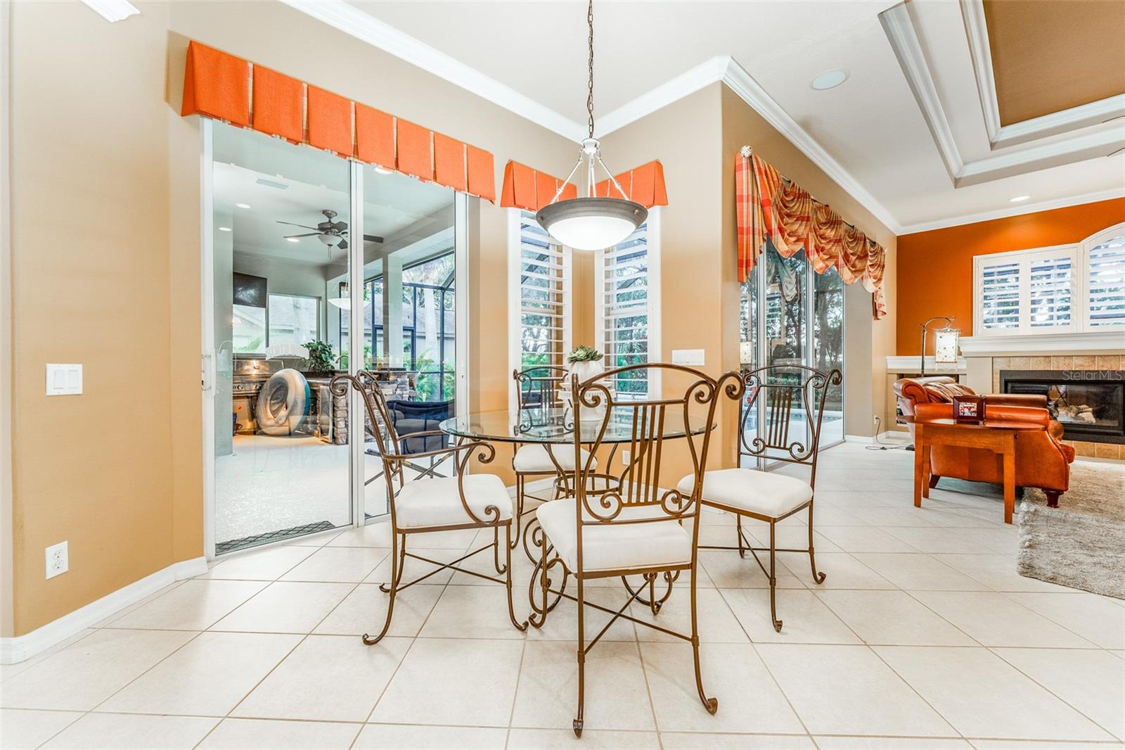 Dinette Area Adjacent to Kitchen Overlooking the Sparkling Pool & Outdoor Living Space