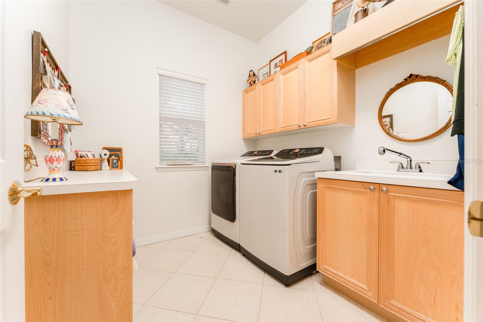 Laundry Room with Washer & Dryer that Convey, Cabinets, Folding Table & Utility Sink