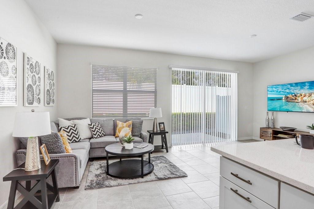 Great Room with Sliders Out to Backyard Patio for Outdoor Entertaining! (stock photo of model home)