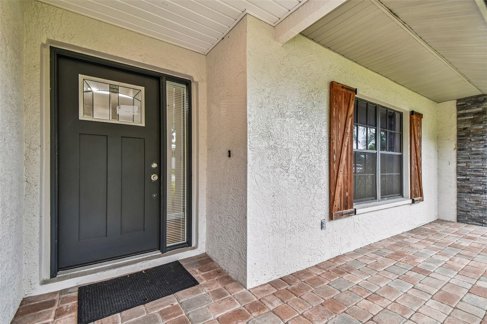 Front porch, paved with barn style shutters
