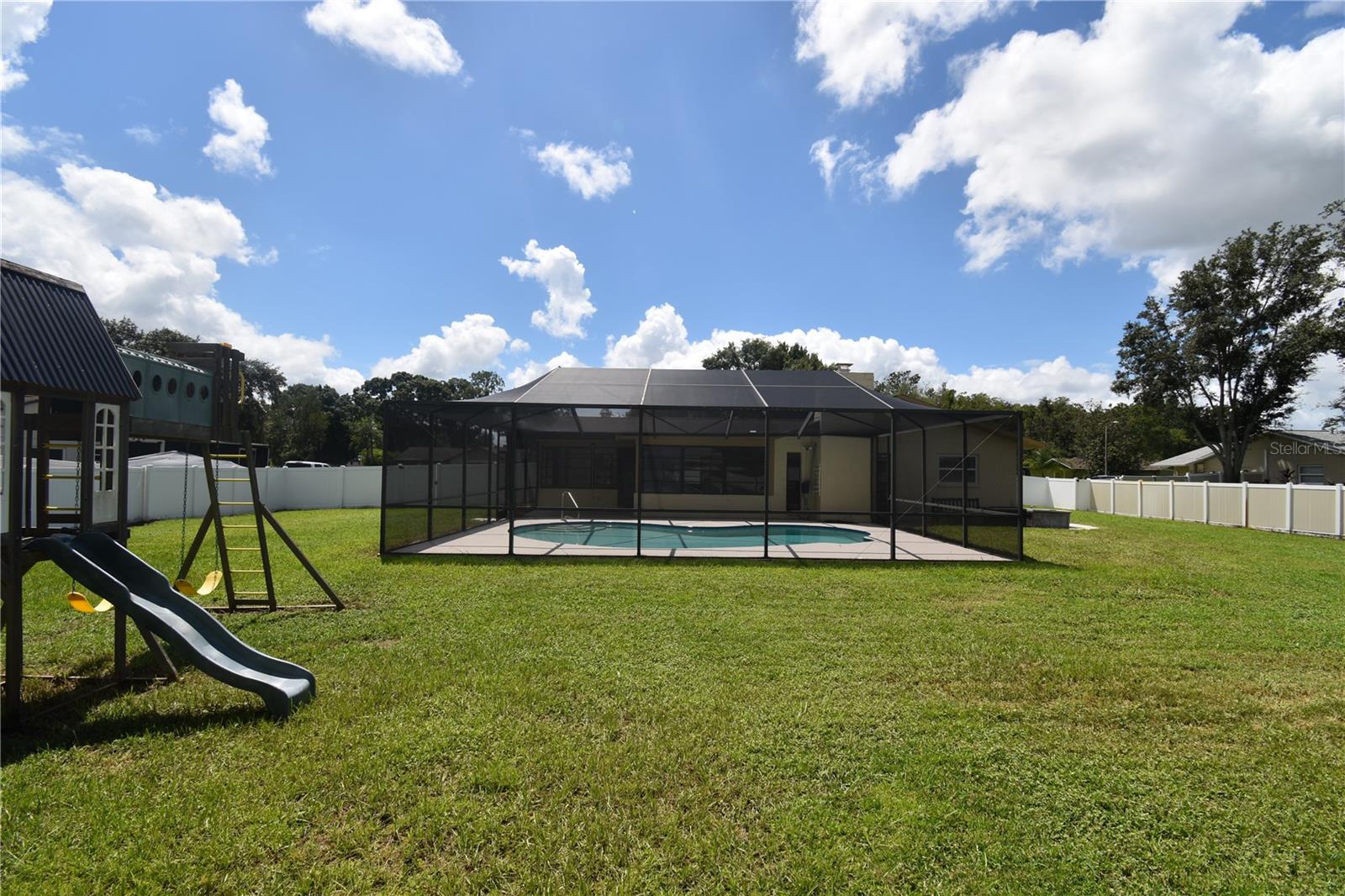 Backyard pool and swing set