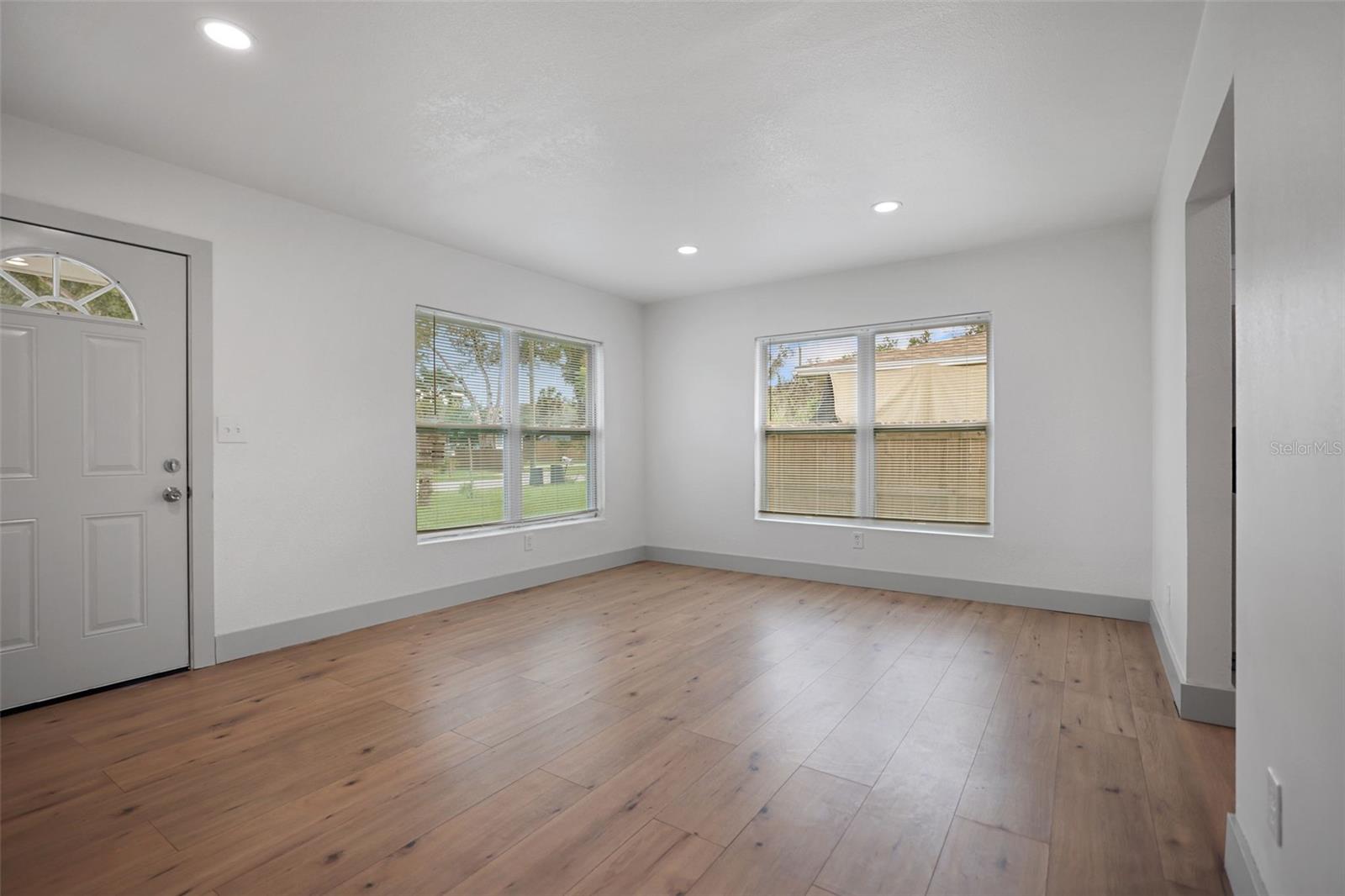 Spacious Living room - new windows - new paint - new recessed lighting - new waterproof flooring - new front door - new molding.