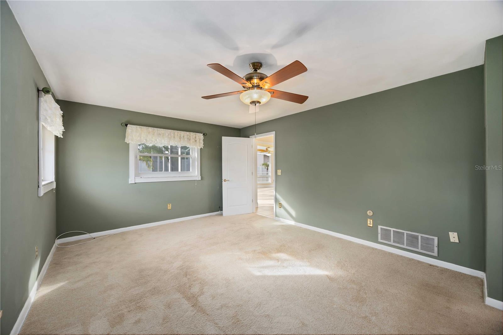 The primary bedroom has plush carpeting.