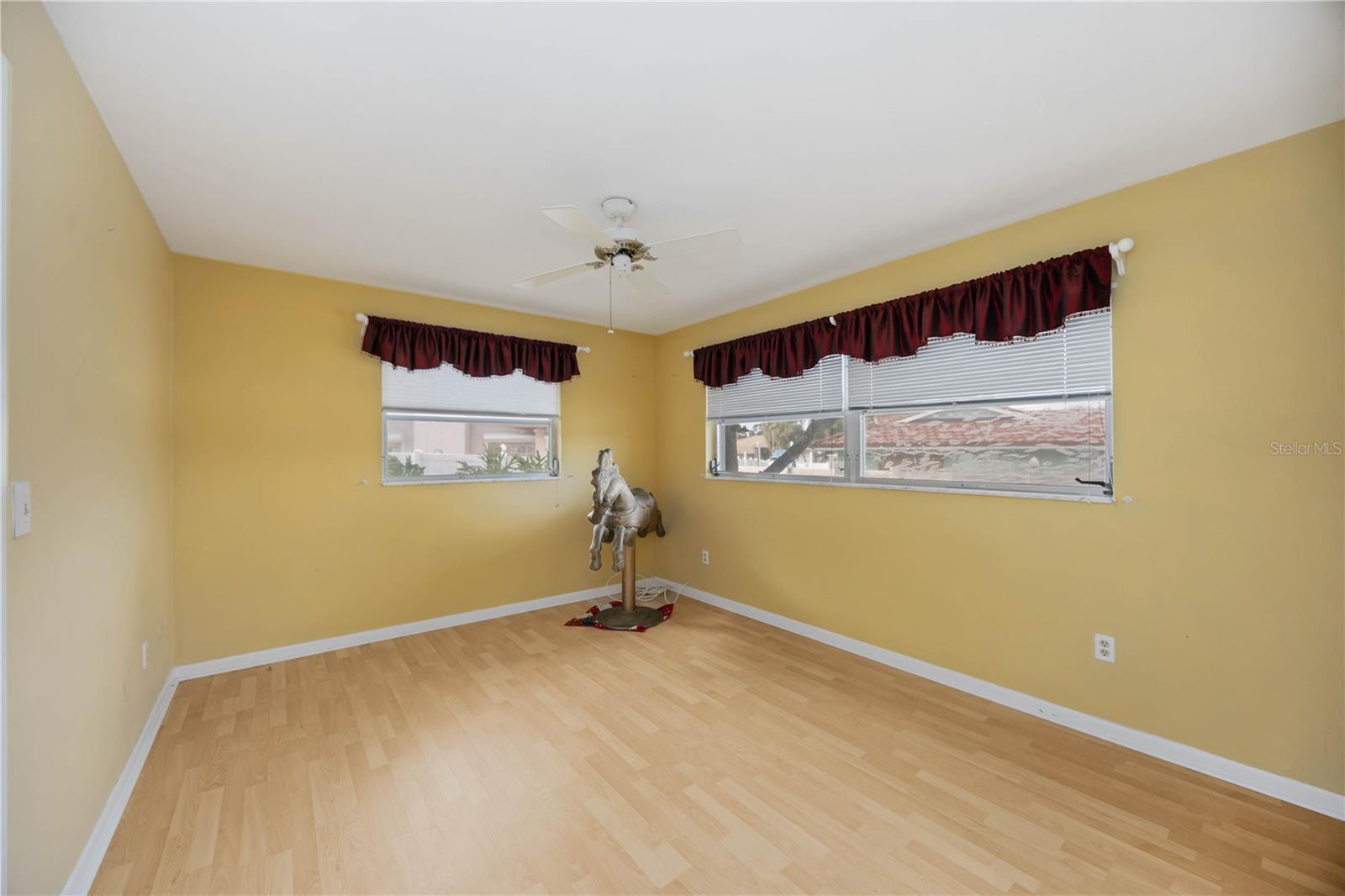 Guest bedroom has laminate floors.