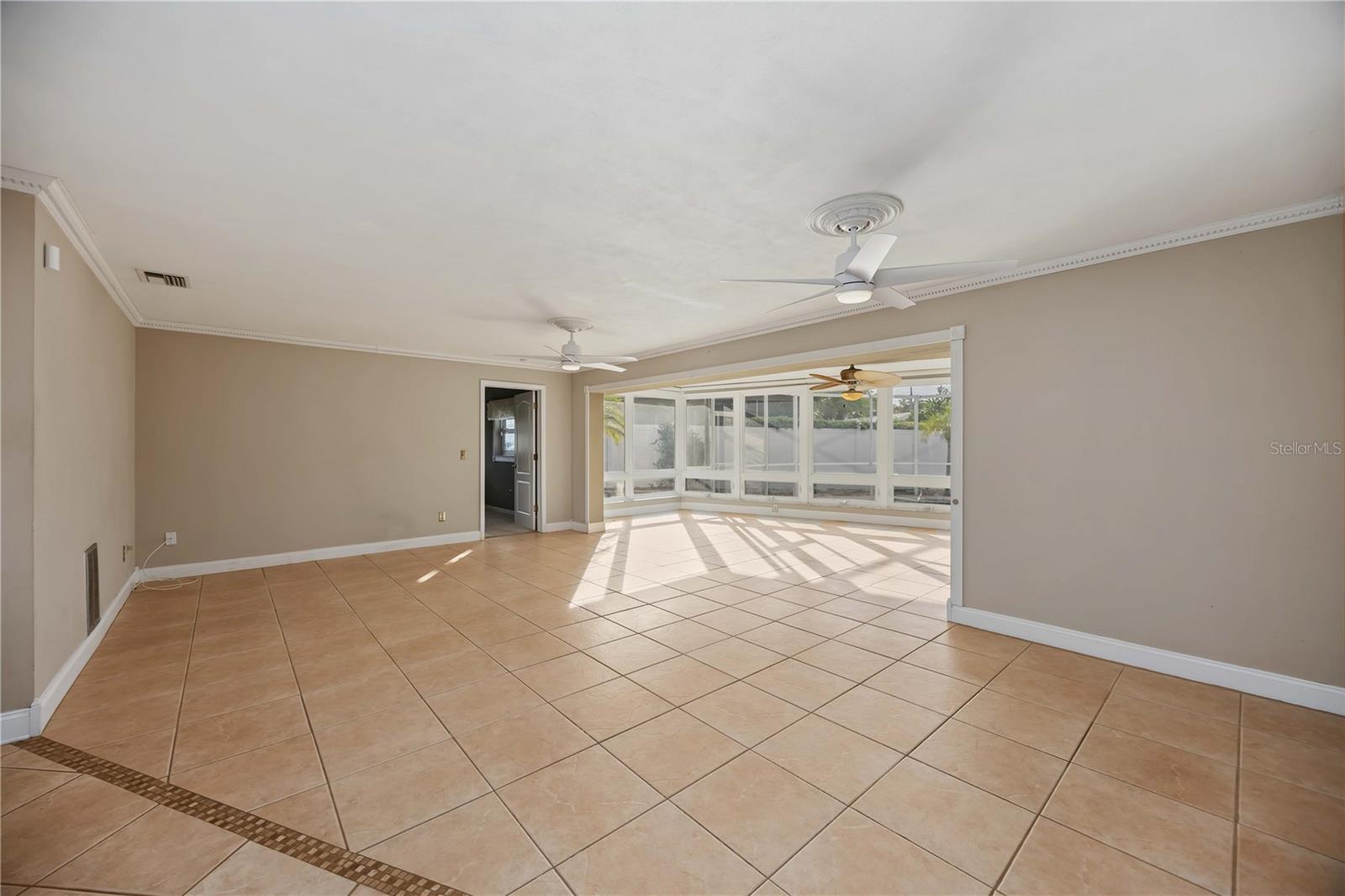 As you enter this home you will see the beautiful pool area from the expansive living room!