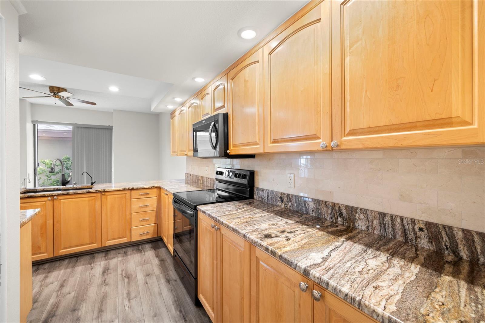 Update kitchen with granite counters, wood cabinets great for entertaining