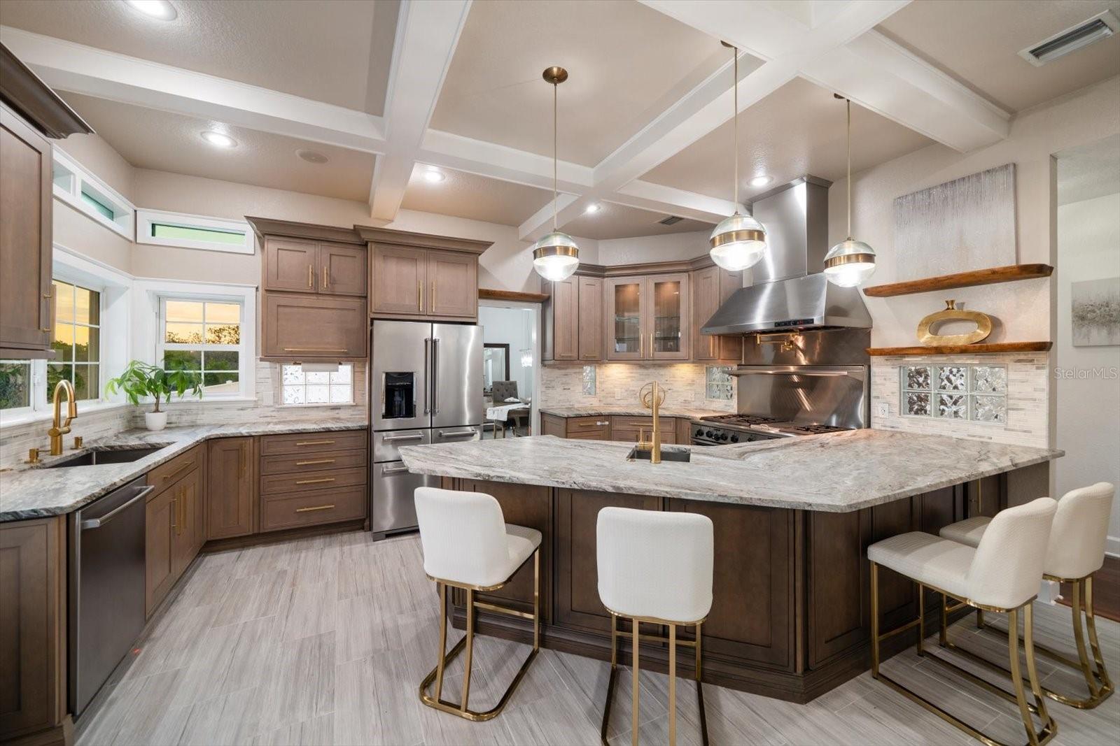 Luxurious and elegant finished are found in the kitchen area from coffered ceilings, designer lighting, high-end appliances and stunning quartzite countertops.