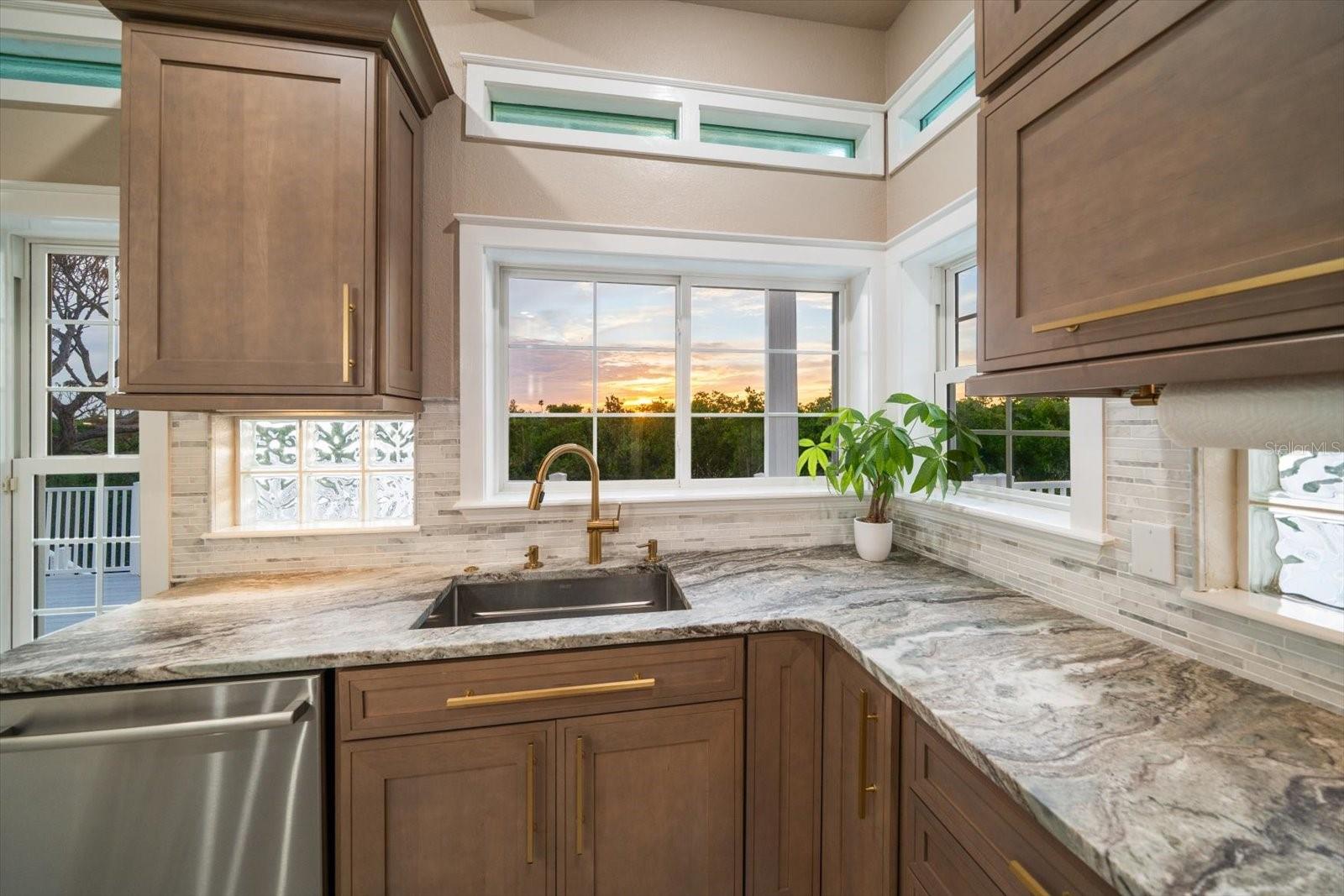 The custom cabinetry makes optimal use of the space in the kitchen with hidden areas for small appliances and easily accessible spaces.
