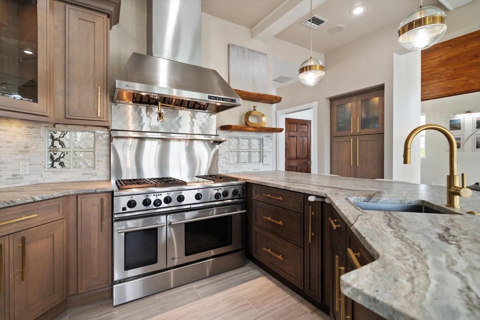 Functionality meets refined elegance in this outstanding kitchen layout providing abundant counter space, and ample storage with built-ins found throughout.