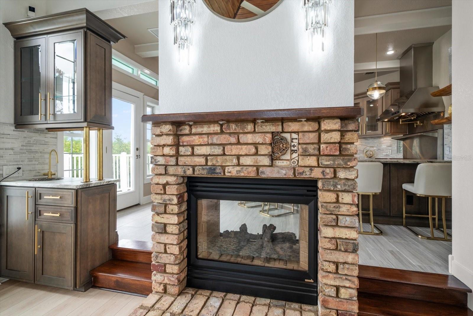 The dual, wood-burning fireplace provides warmth to both the living and kitchen areas.