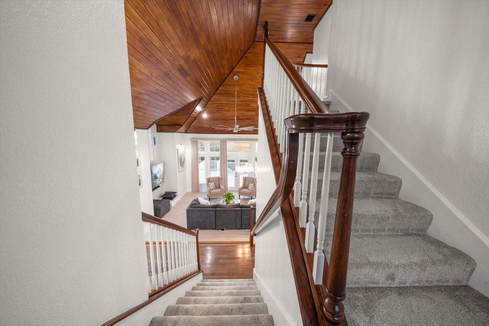 Stairway leading from the main living level to the third level where the primary suite is located.