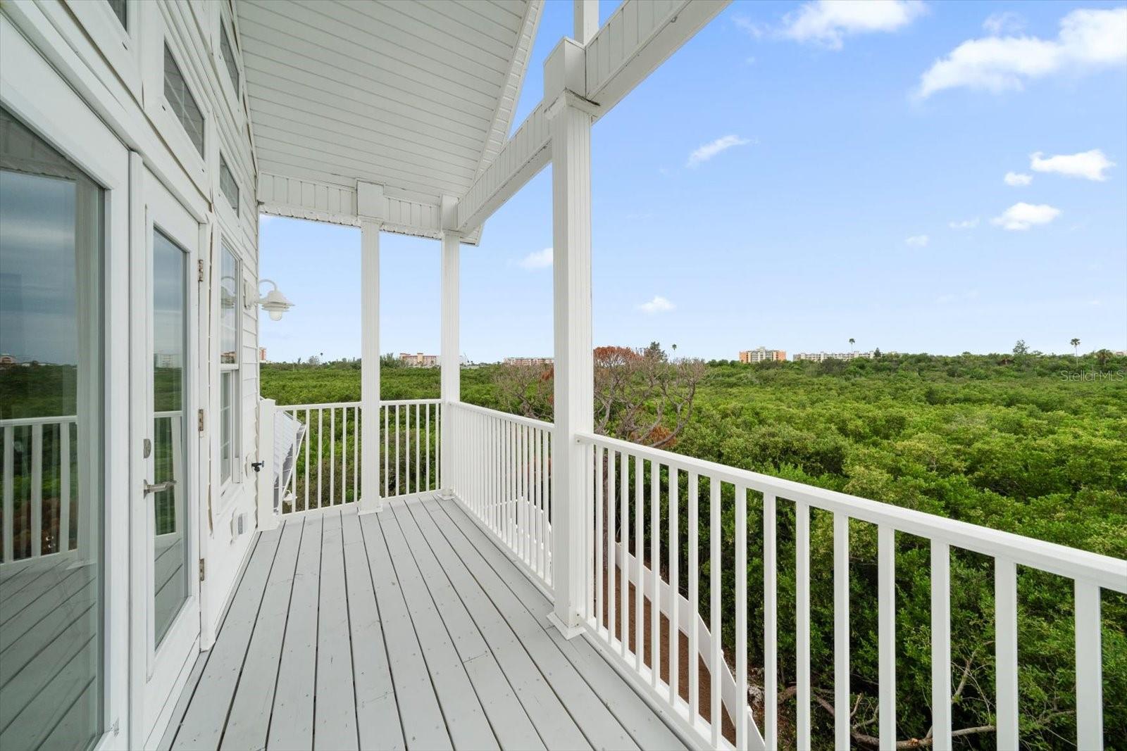 Primary balcony off of the primary suite provides 180 degree views over the mangroves.