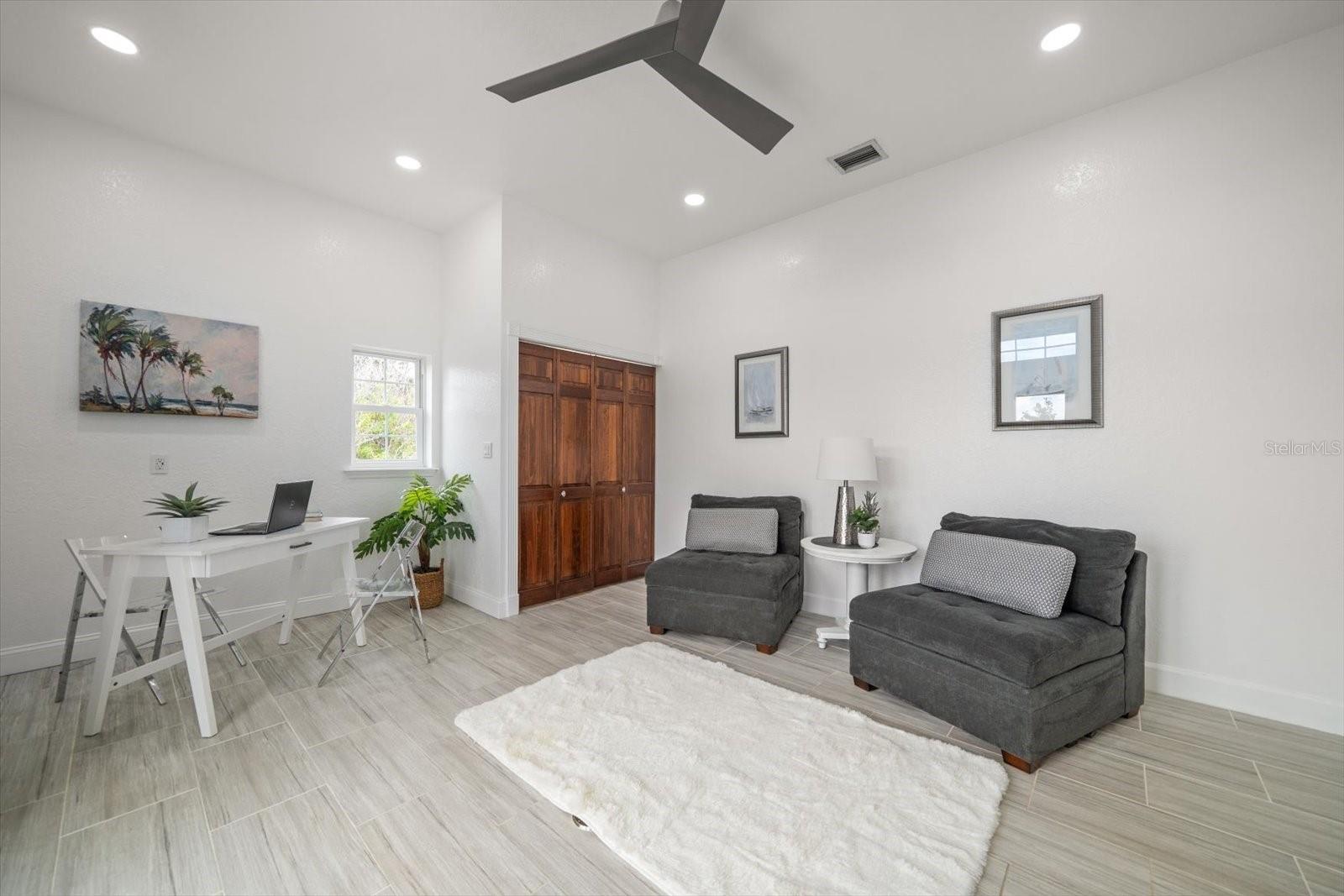 The office space or fourth bedroom is located on the main-living level and provides private access to the balcony.