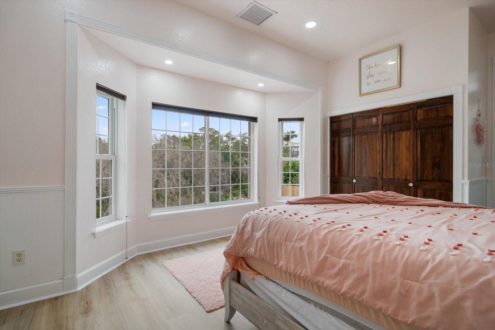 Natural light fills this spacious bedroom with large closet.