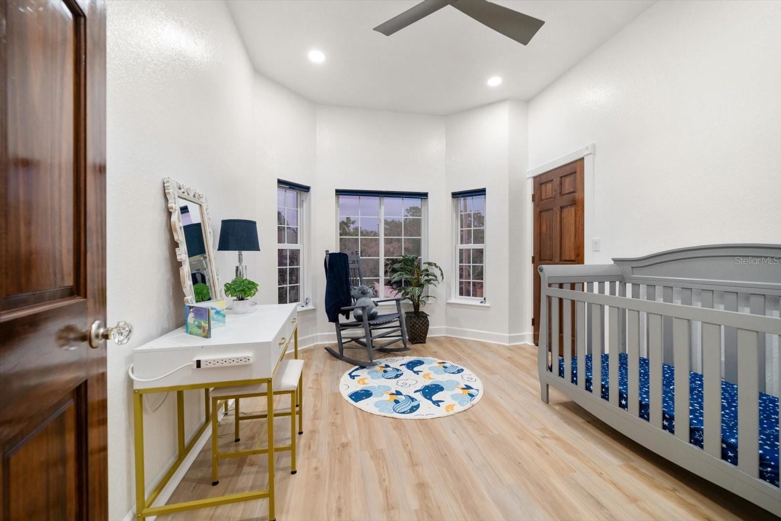 The third bedroom located on the main-living level features bay windows and a walk-in closet.