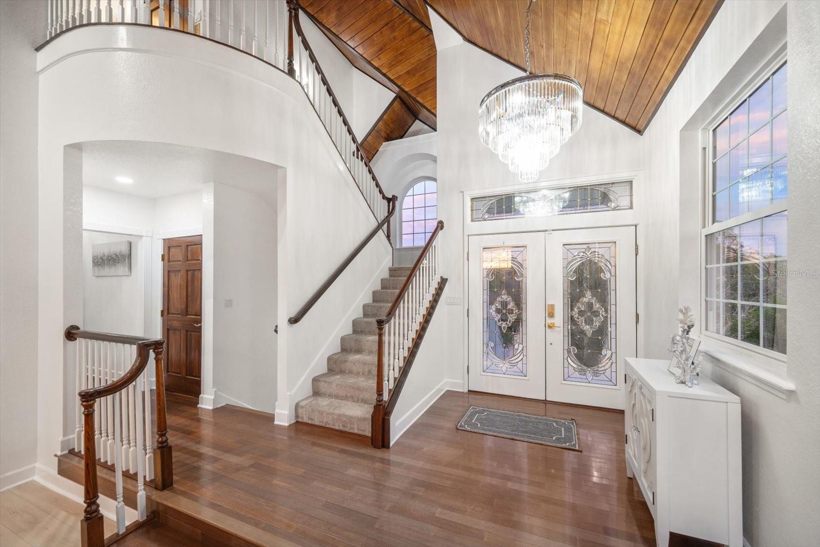 Impressive entry! Met with soaring ceilings, wood finishes throughout and bounds of natural light.