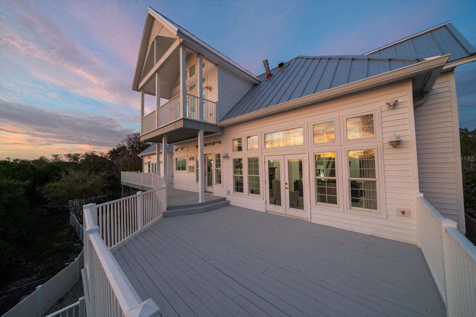 Lovely open deck and balcony off of the main living level, for an exquisite outdoor setting.