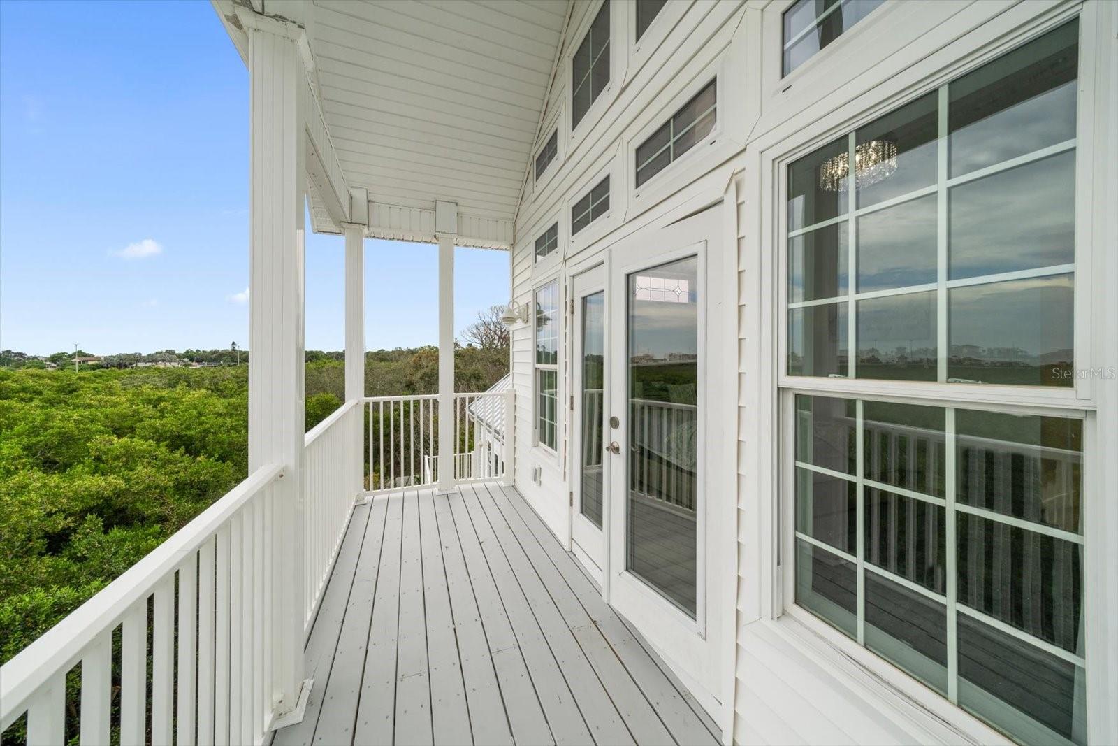 Private balcony accessed from the primary bedroom.