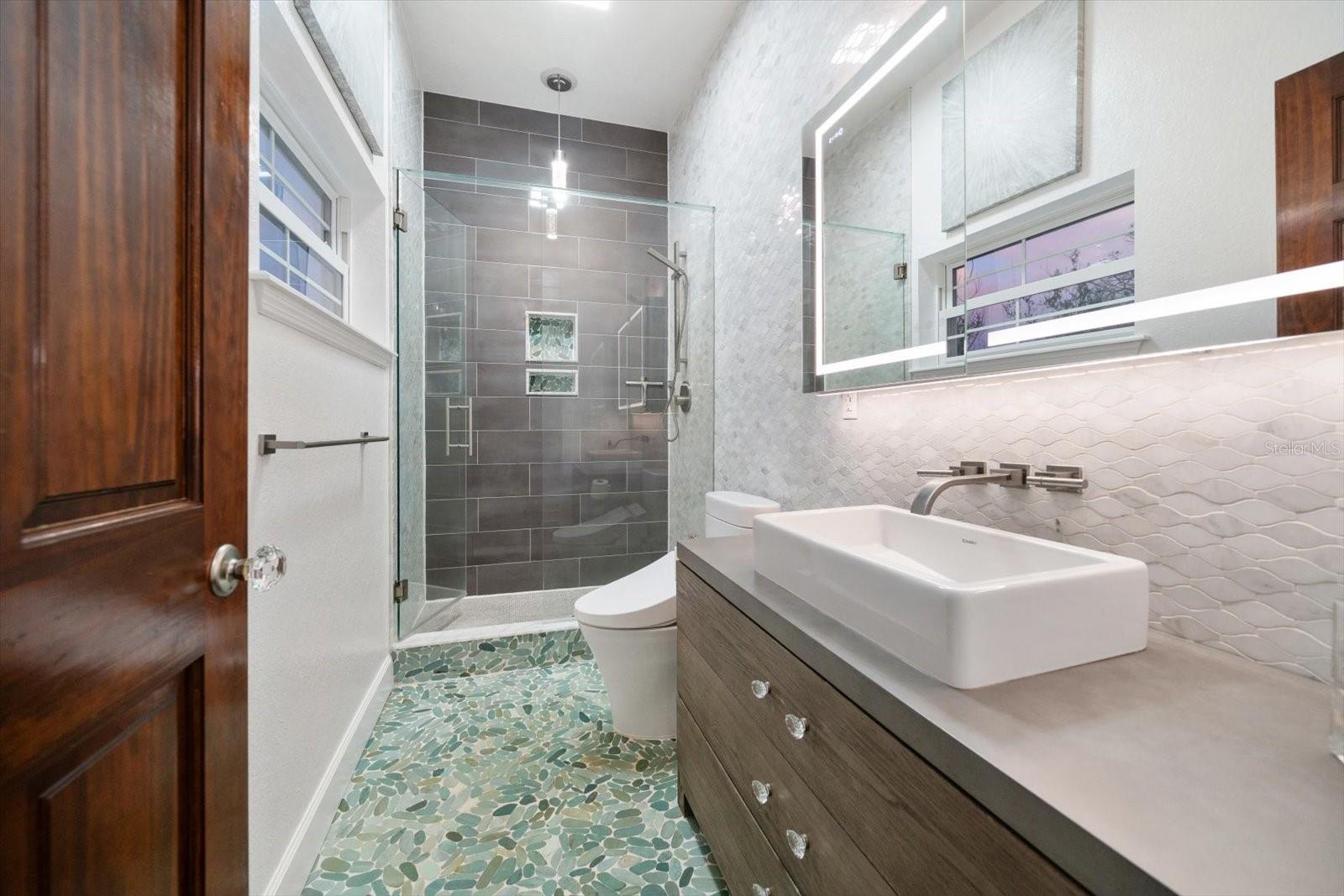 Impressive guest bathroom located on main-living level servicing the three guest bedrooms on this level.