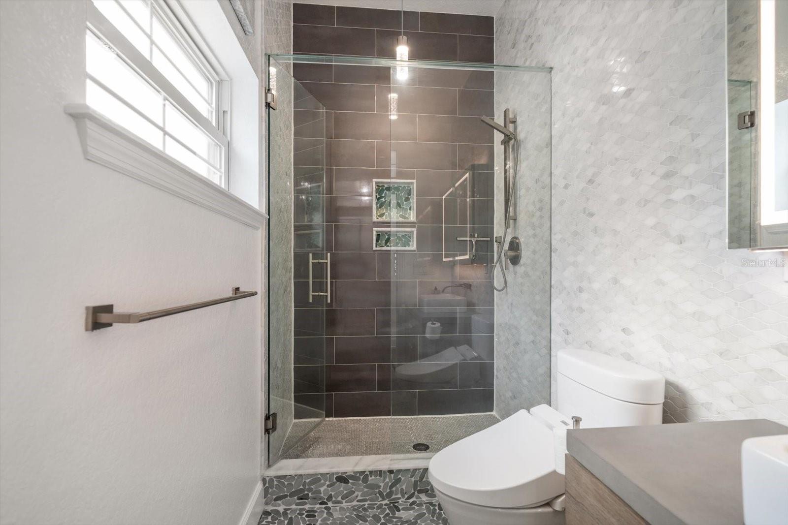 Guest bathroom on main-living level with walk-in shower.
