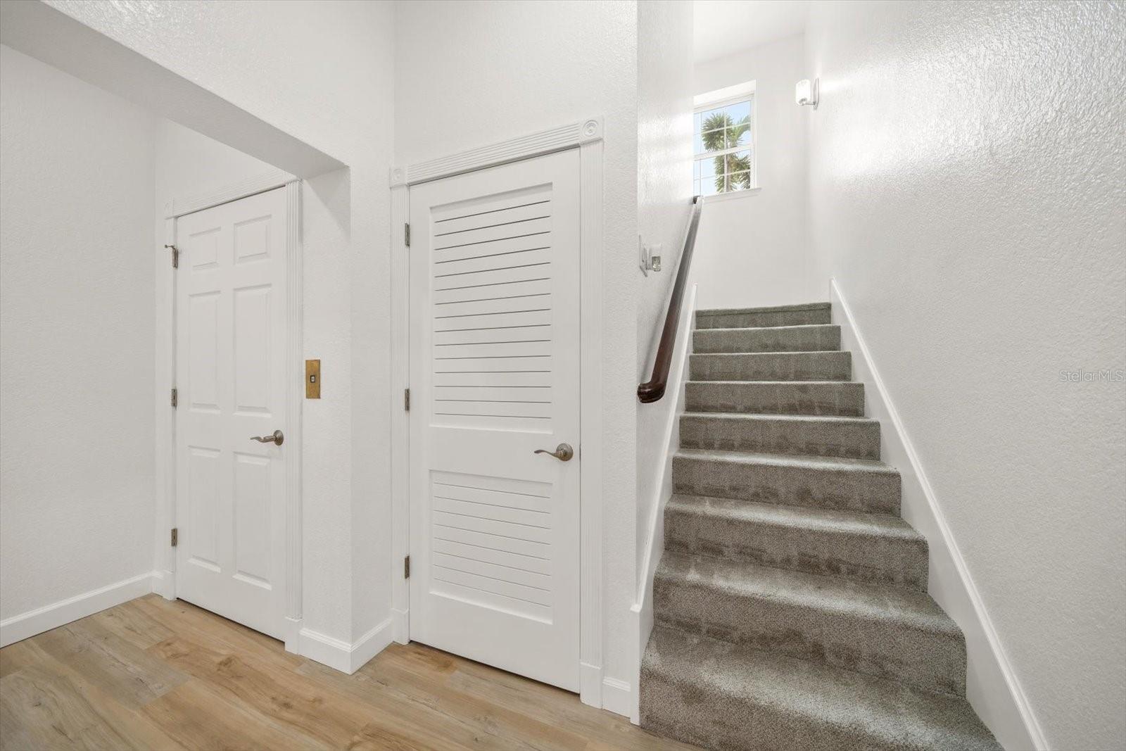 The staircase leads to all levels of the property including the ground-level that is comprised of a flex space and oversized garage area.