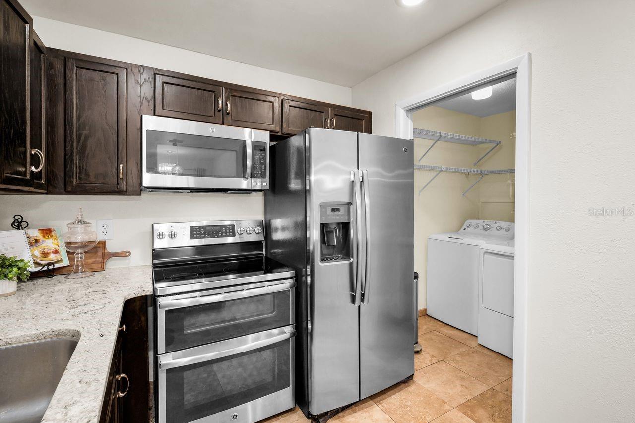 Laundry just of the kitchen offers convenient additional storagestorage