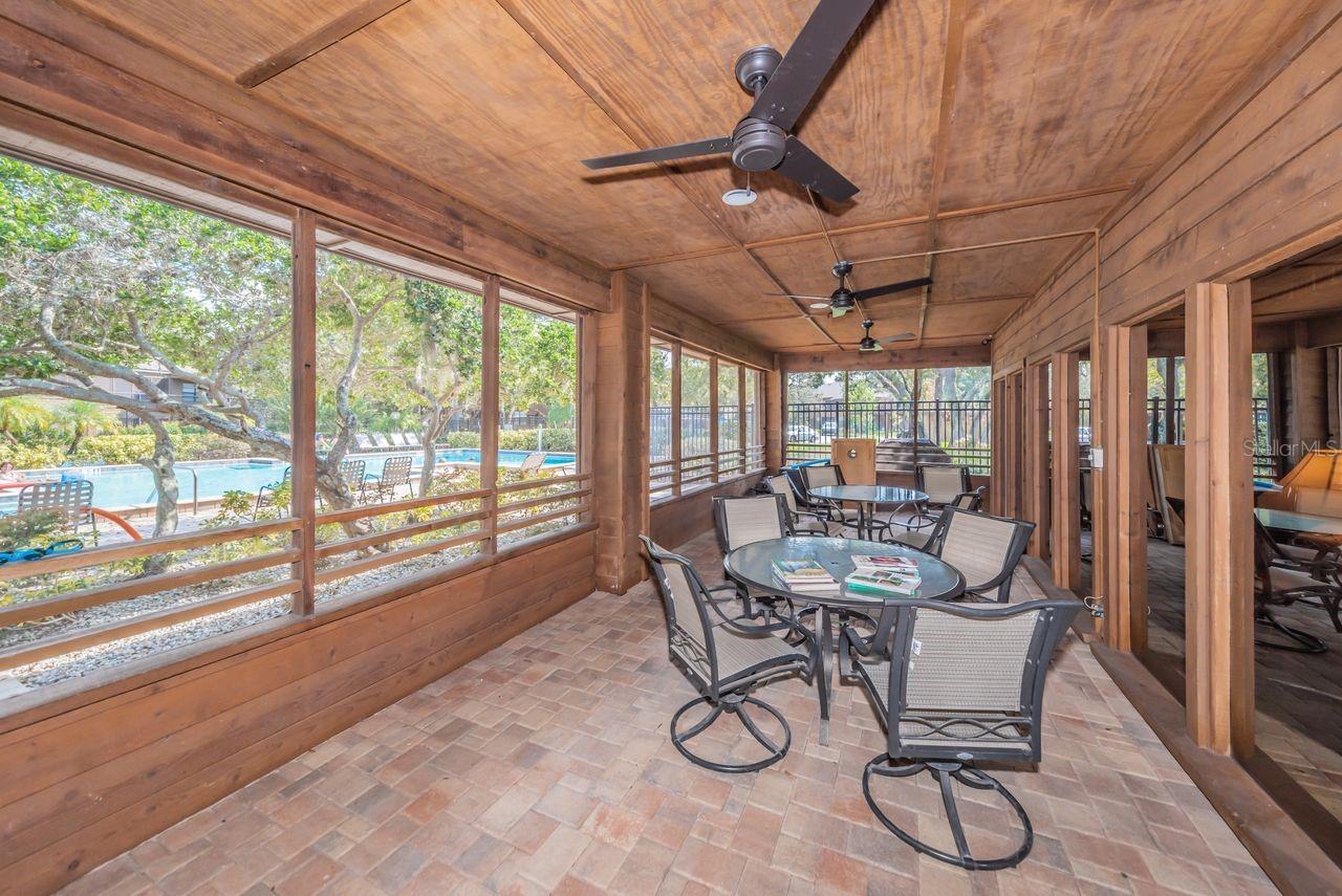 Screened porch offers view of pool.