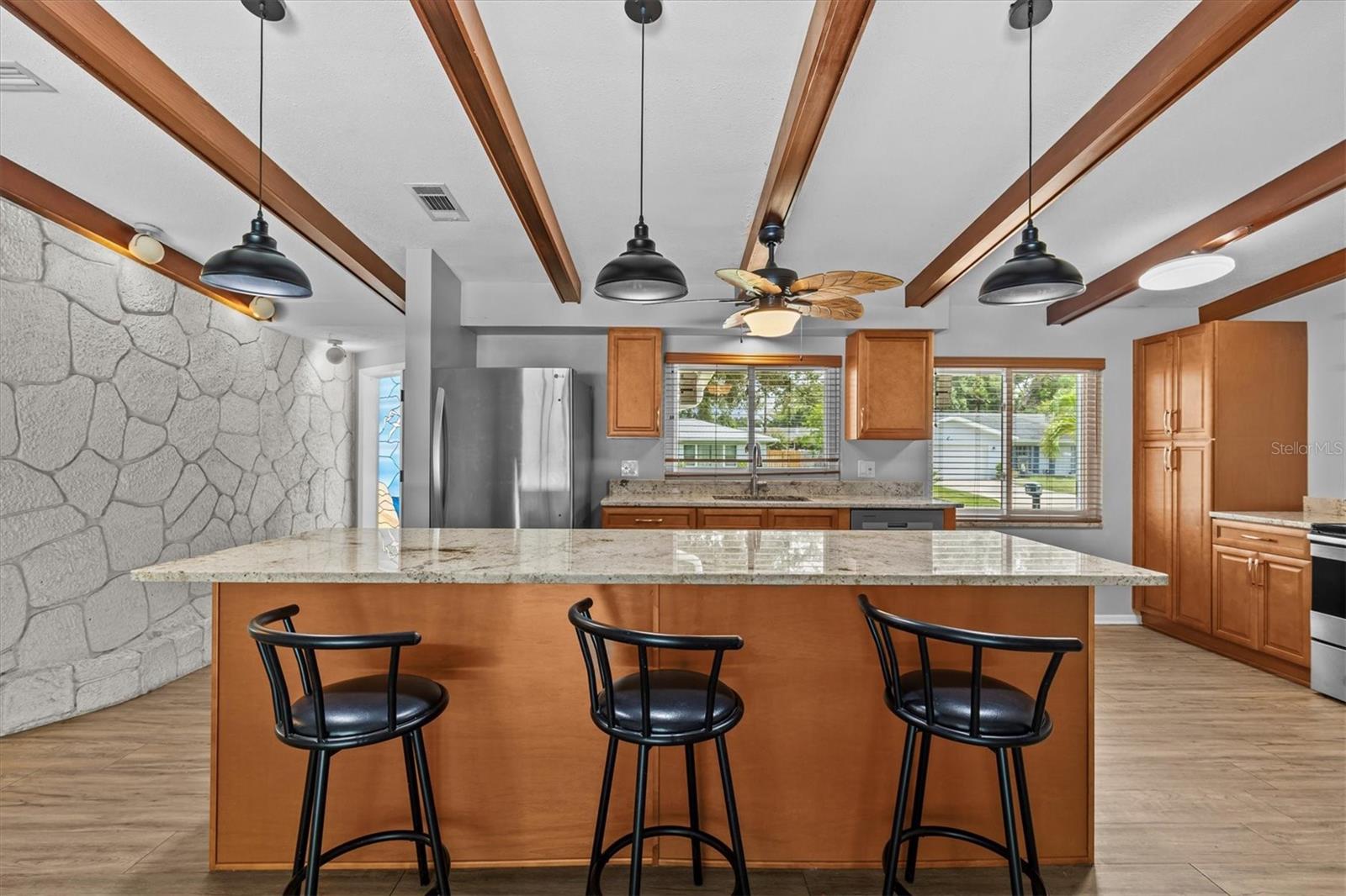 wood cabinets and exposed beams create a warm and welcoming vibe.