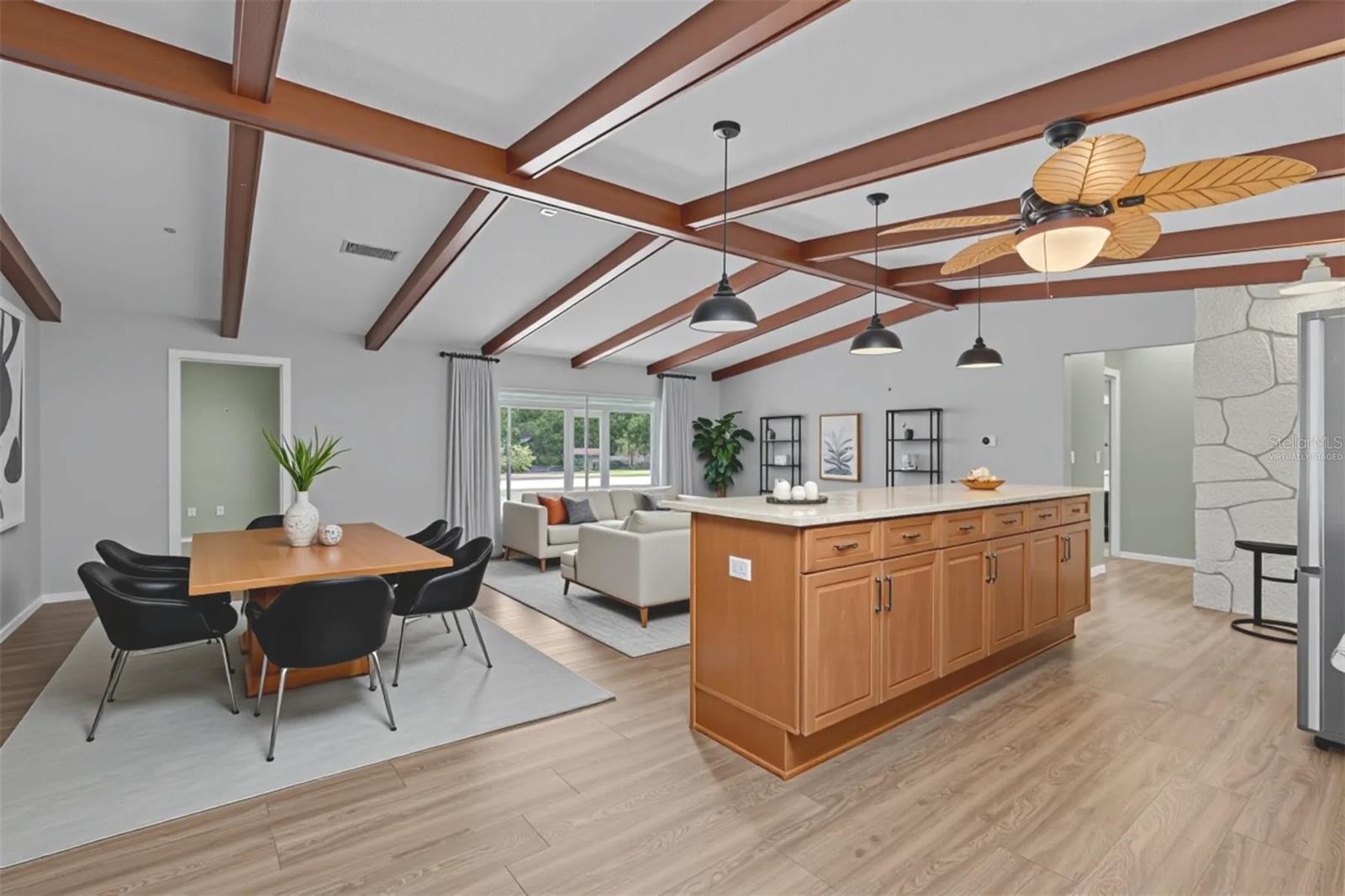 Virtually staged great room with one option for dining and living.