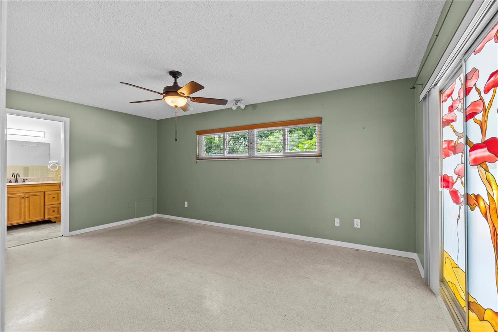 original terrazo tile floors are in great condition. Custom stain glass sliding glass doors and wood blinds.