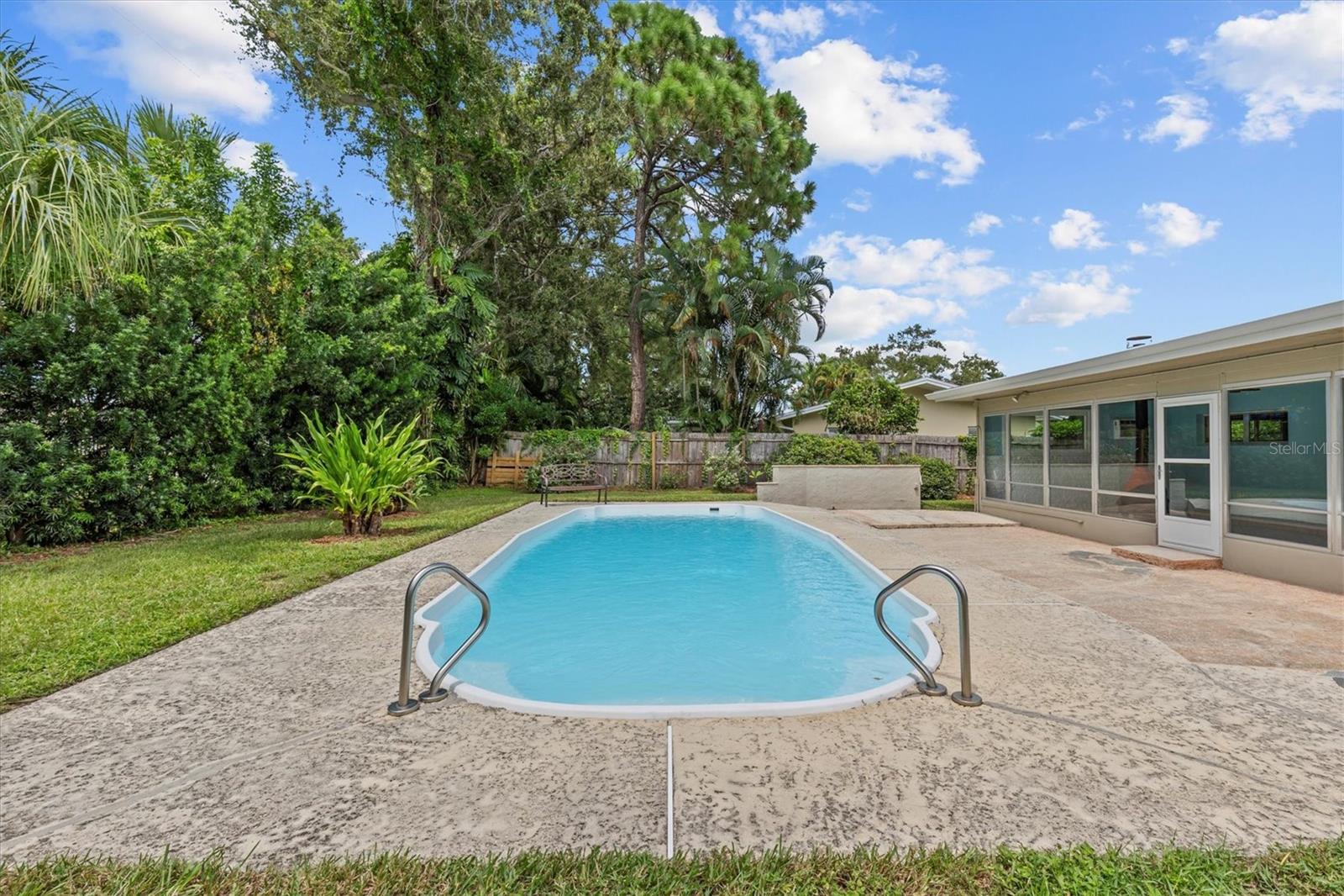 Sparkling oval fiberglass pool for entertaining family and friends.