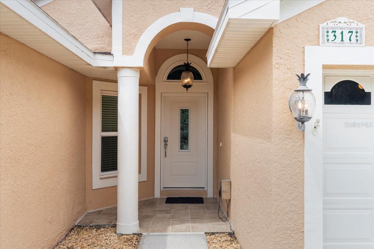Front door entry with portico and stylish pilar