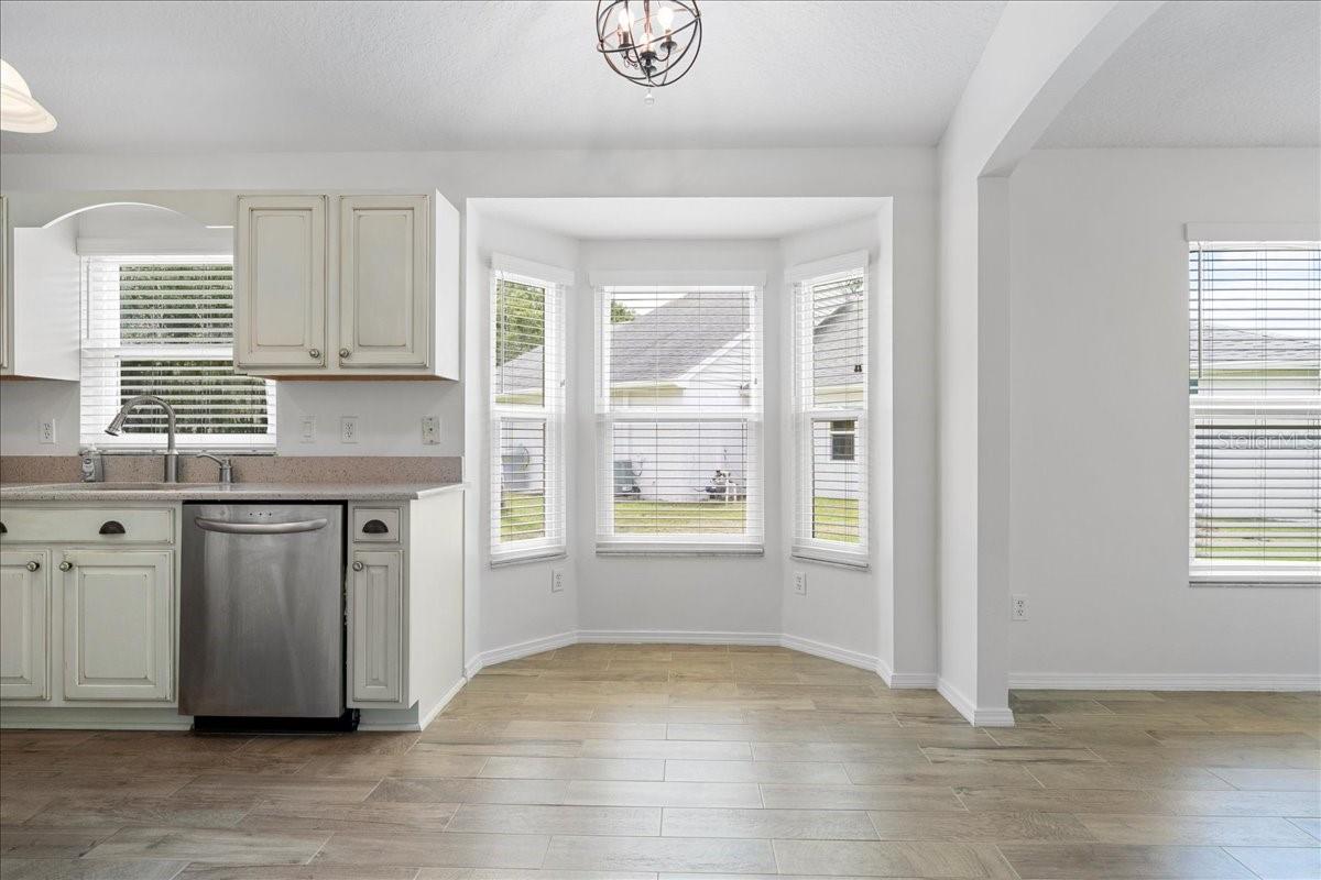 Eat-in kitchen has breakfast nook at the bay window.