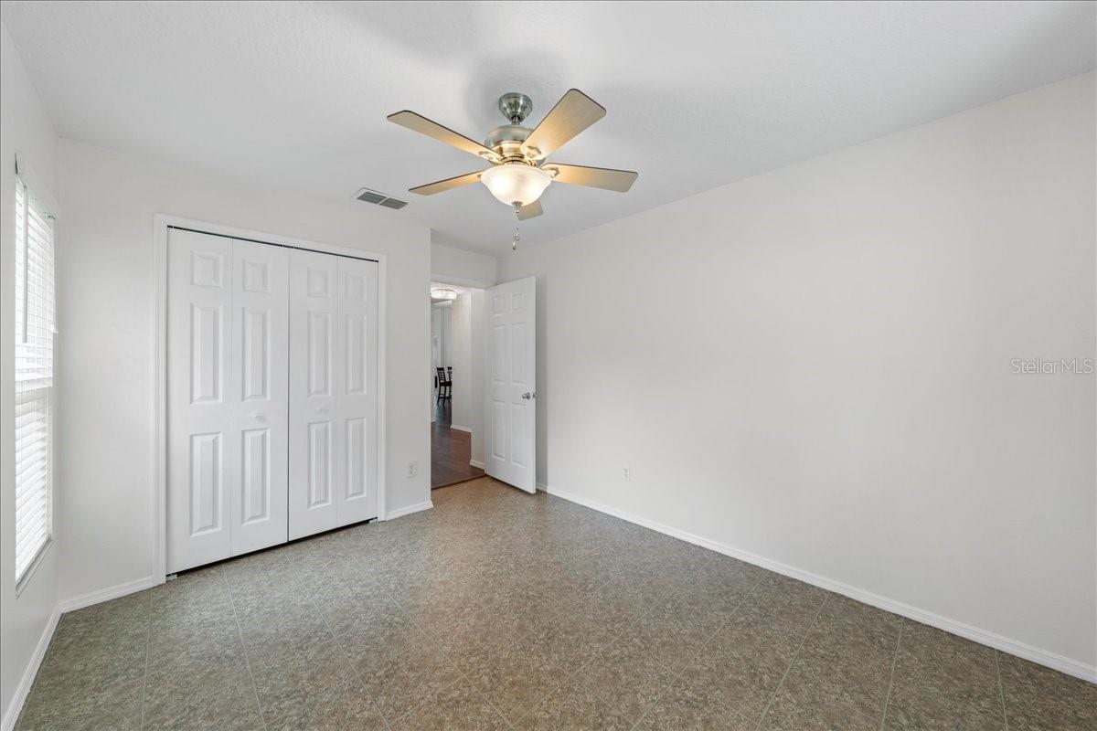 Second bedroom enjoys a recessed window with view out to conservation in front and a wall closet.