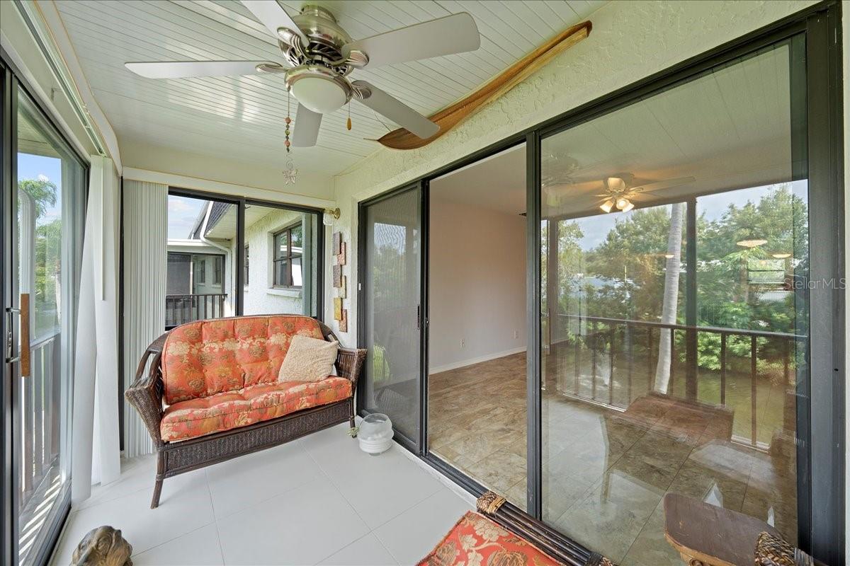 balcony with sliders at railing that open to a screen for fresh air and the sounds of nature