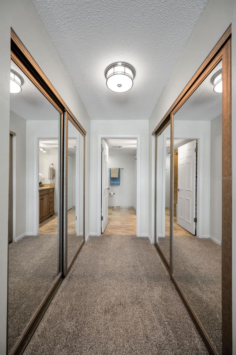 Primary Double Wall Closets with mirrored doors lead to Primary Ensuite Bath