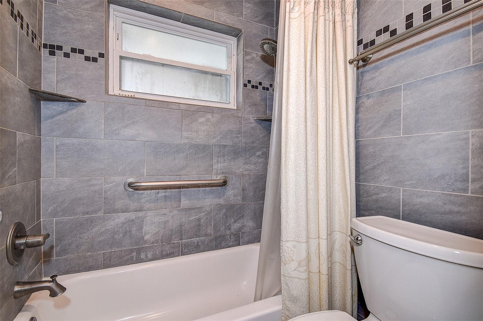 TUB, SHOWER AND TOILET SEPERATED FROM SINK AREA SO THAT TWO PEOPLE CAN ACCESS THE BATHROOM AT ONCE.