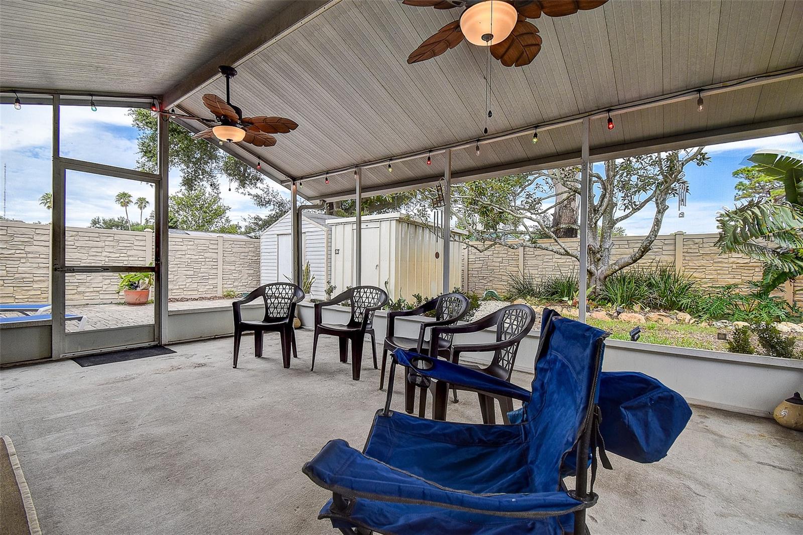 BACK SCREENED IN PATIO WITH FANS, LIGHTS AND PLETY OF SPACE FOR ENTERTAINING