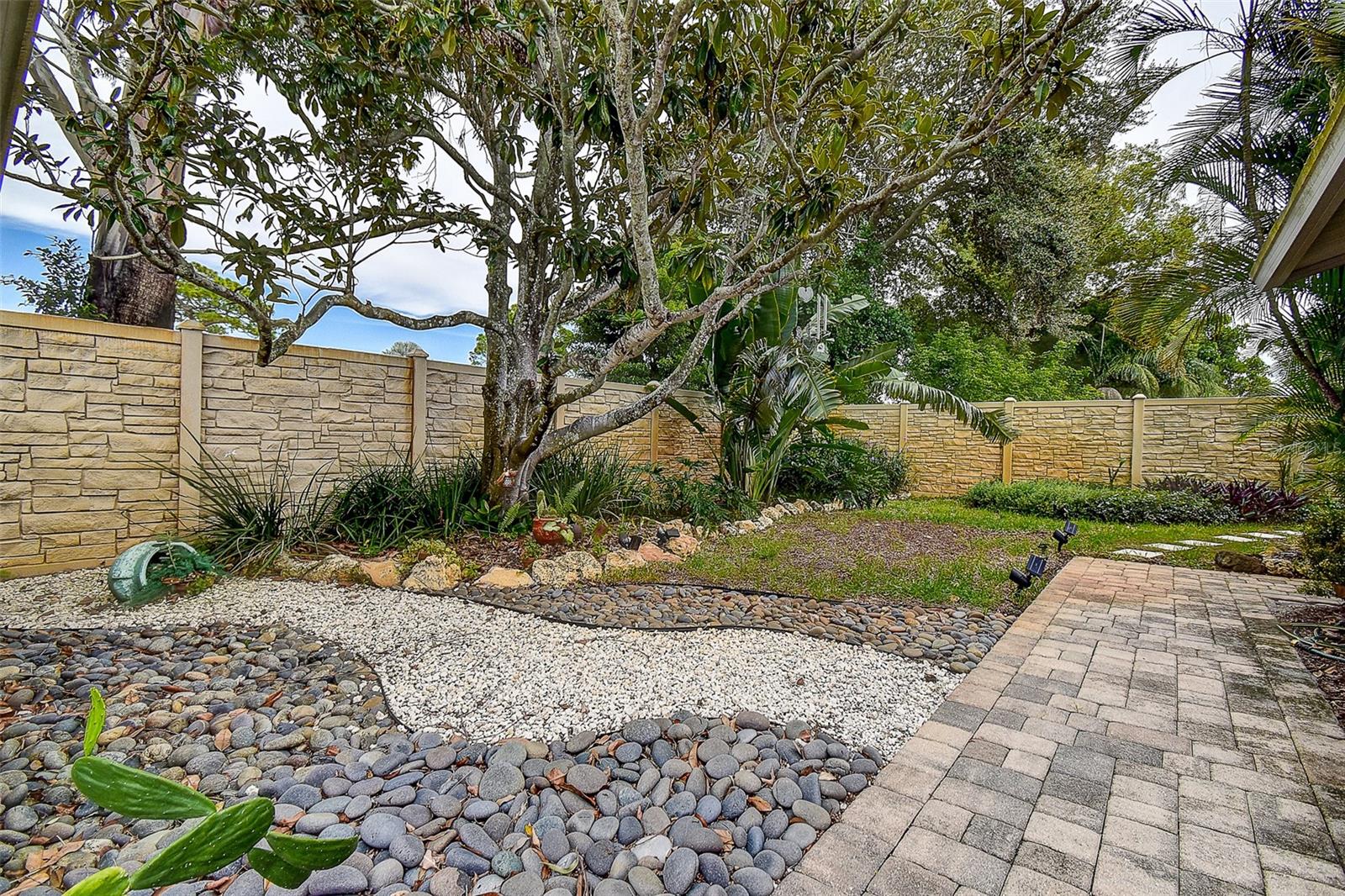 BACKYARD IS MANICURED AND INVITING.
