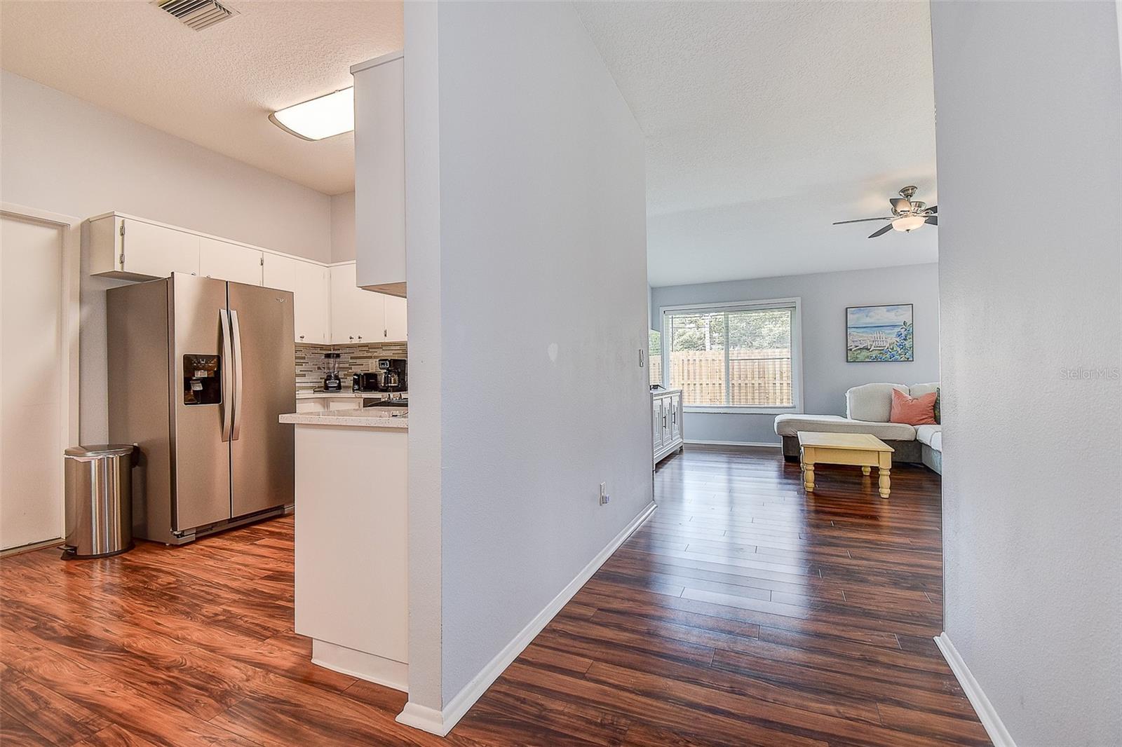 ENTRY WAY INTO LIVING ROOM AND KITCHEN ON LEFT