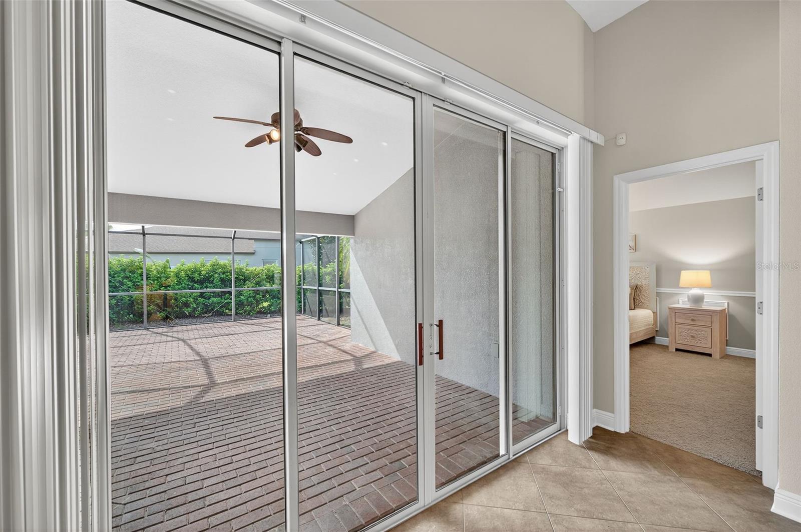 Sliders to Large Lanai and Doorway to Primary Bedroom at Back of House.