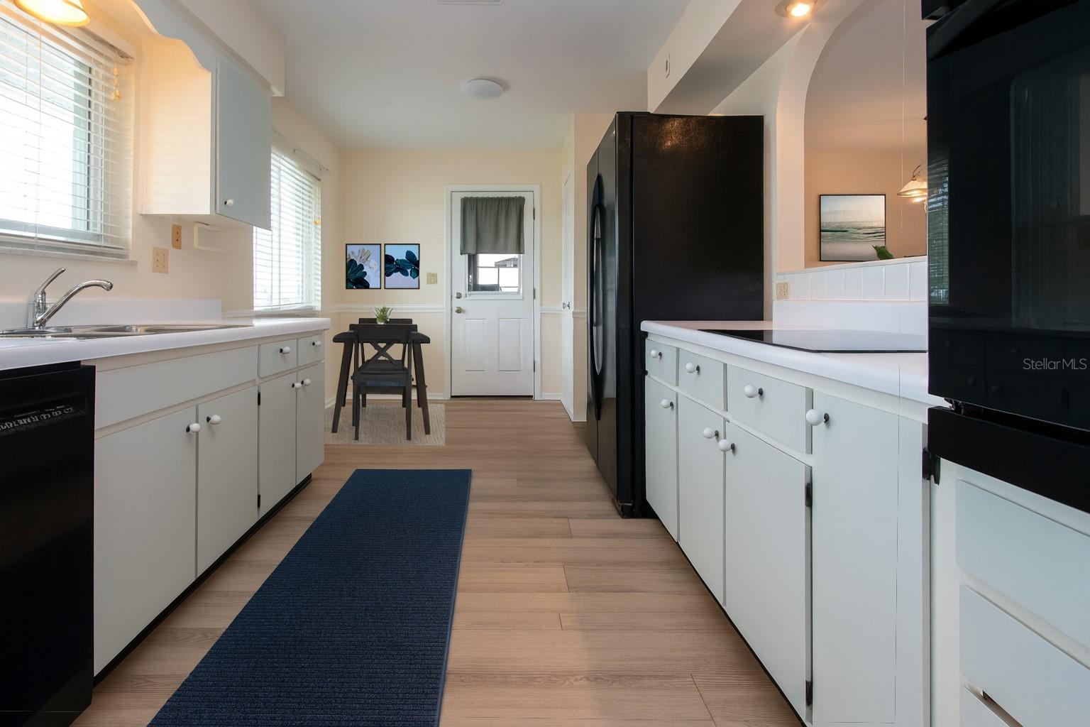 Staged view of galley kitchen and breakfast nook