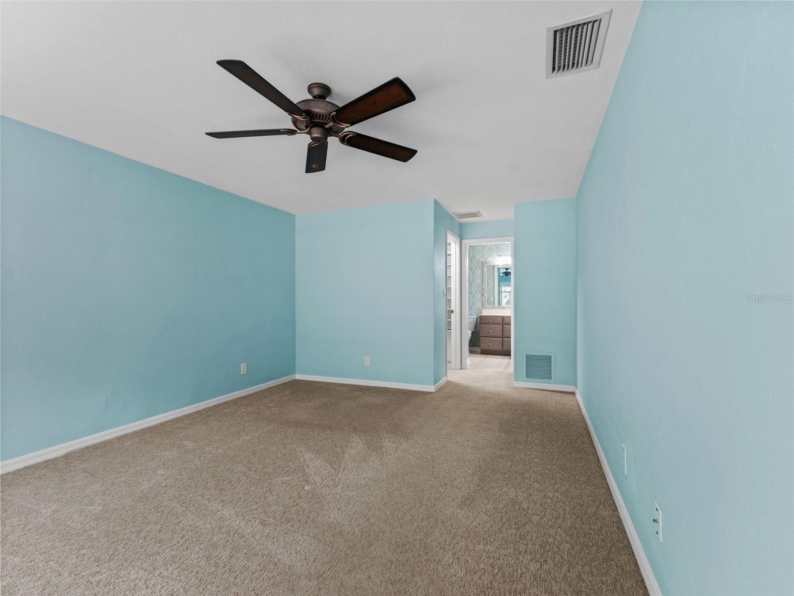 A large primary bedroom with plenty of space for furniture and personal touches