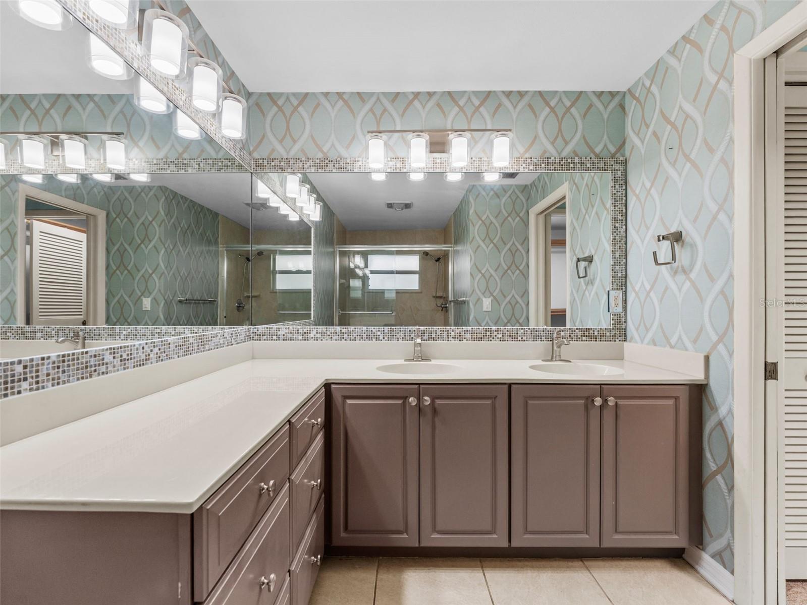 Primary ensuite features a double sink vanity with ample countertop space