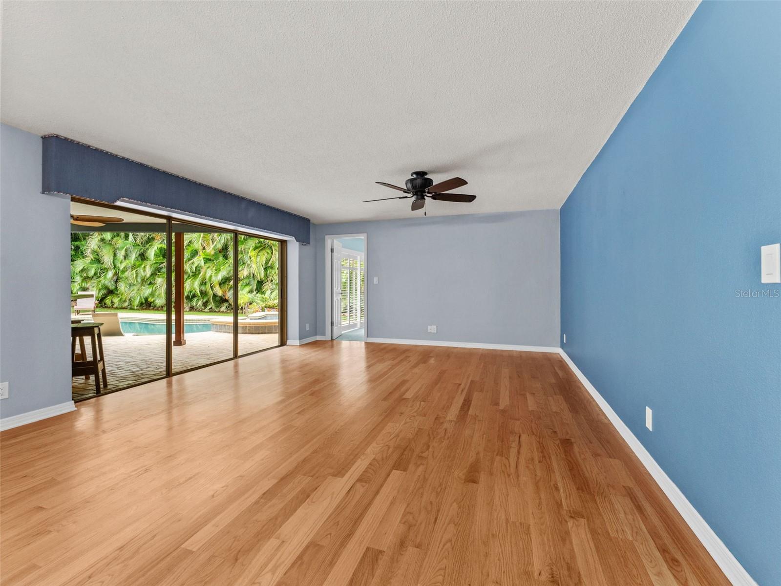 Living room views with sliding doors straight out to the pool and backyard oasis