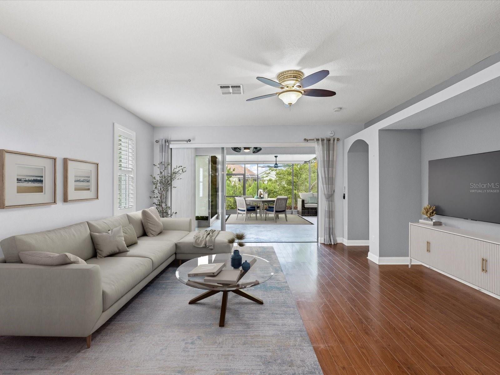 Virtually Staged Living Room and covered portion of back screened patio