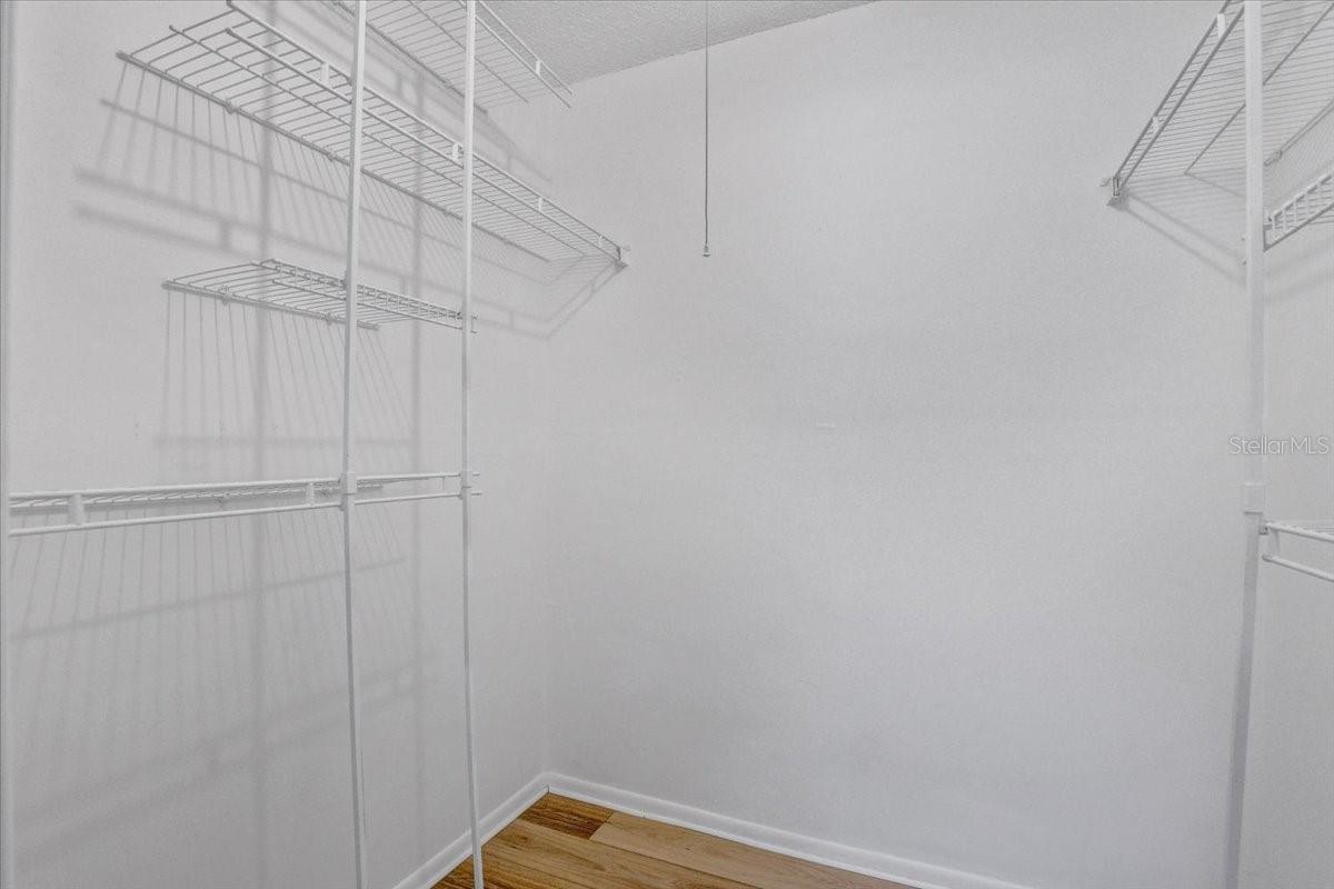 Primary bedroom walk-in closet