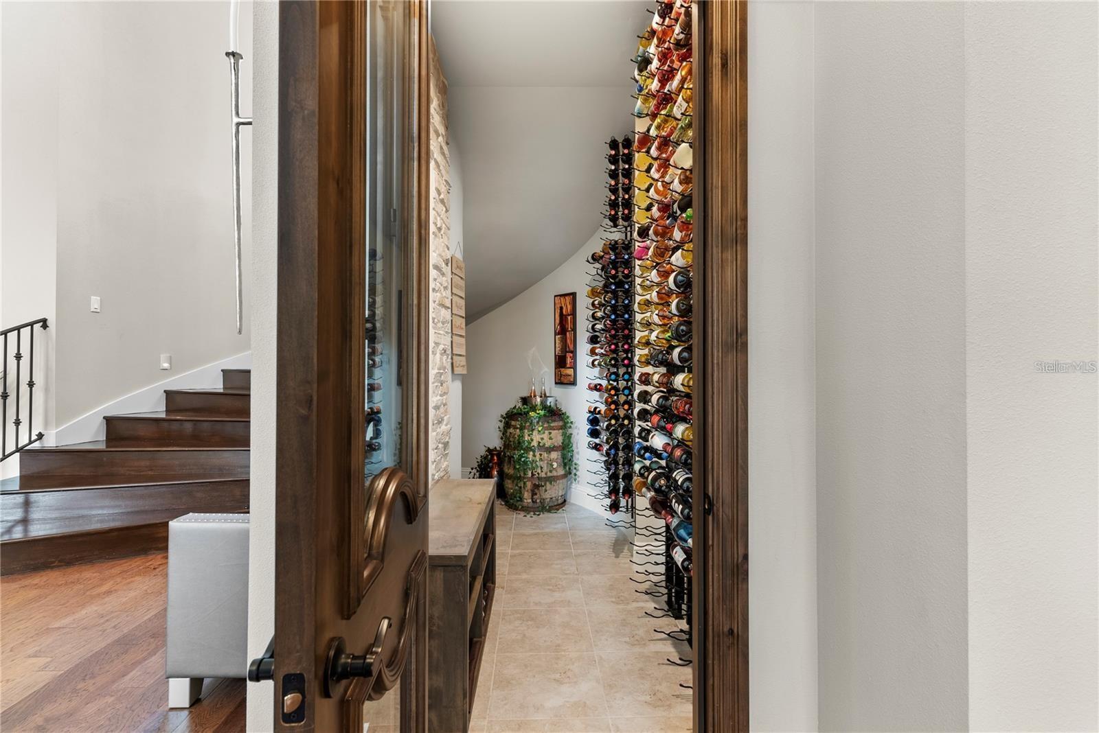 The home boasts a temperature-controlled wine cellar, elegantly positioned next to the dining room for effortless entertaining and refined storage.