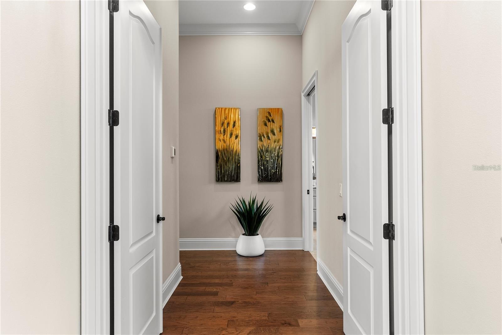 The owner’s retreat on the first floor is a private sanctuary, featuring a double-door entry, dual walk-in closets with built-in shelving, and breathtaking pond views.